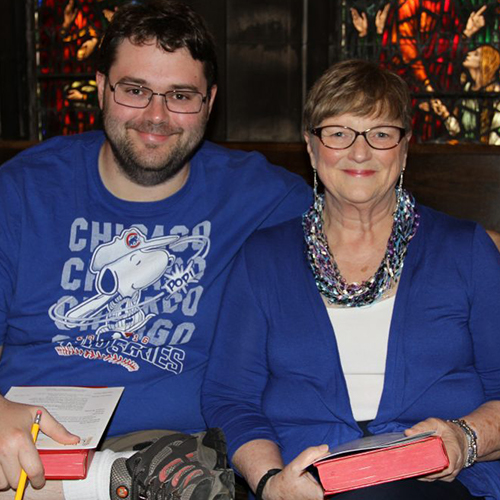 two people in blue smiling at the camera