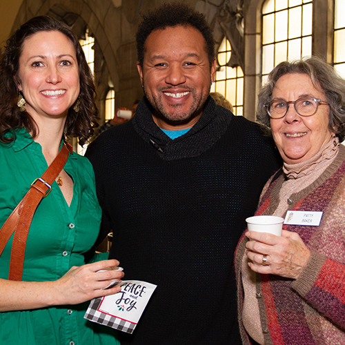 three people smiling at the camera